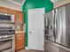 Kitchen featuring stainless steel appliances, wooden cabinets, tile backsplash, and corian countertops at 8728 Tom Noon Ave # 103, Las Vegas, NV 89178