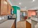 Kitchen featuring stainless steel appliances, wooden cabinets, tile backsplash, and corian countertops at 8728 Tom Noon Ave # 103, Las Vegas, NV 89178