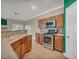 Kitchen featuring stainless steel appliances, wooden cabinets, tile backsplash, and corian countertops at 8728 Tom Noon Ave # 103, Las Vegas, NV 89178