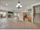 Open-concept living area featuring a fireplace and a modern kitchen at 8728 Tom Noon Ave # 103, Las Vegas, NV 89178