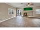 Bright living room with tile flooring, a fireplace, and a sliding glass door providing backyard access at 8728 Tom Noon Ave # 103, Las Vegas, NV 89178
