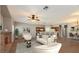 Bright, open living area with hardwood floors, fireplace, ceiling fan, and bar seating in the kitchen at 8728 Tom Noon Ave # 103, Las Vegas, NV 89178