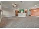 A spacious living room featuring tile flooring, open to the kitchen with a ceiling fan, and neutral wall colors at 8728 Tom Noon Ave # 103, Las Vegas, NV 89178