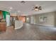 A spacious living room featuring tile flooring, neutral wall colors, and a ceiling fan with an open layout to the kitchen at 8728 Tom Noon Ave # 103, Las Vegas, NV 89178