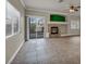 Spacious living room featuring tile floors, a stone fireplace, and sliding glass doors to the backyard at 8728 Tom Noon Ave # 103, Las Vegas, NV 89178