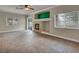 Inviting living room with a stone fireplace, ceiling fan, and sliding glass doors to the backyard at 8728 Tom Noon Ave # 103, Las Vegas, NV 89178
