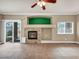 Open living area featuring tile floors, a decorative fireplace, and sliding glass doors to the outdoor space at 8728 Tom Noon Ave # 103, Las Vegas, NV 89178
