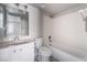 Well-lit bathroom features a vanity with storage and a shower and tub combo at 912 Falconhead Ln # 101, Las Vegas, NV 89128