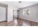 Bright bedroom features wood-look floors and a window at 912 Falconhead Ln # 101, Las Vegas, NV 89128