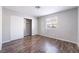 This bedroom is equipped with wood flooring and a sliding-door closet at 912 Falconhead Ln # 101, Las Vegas, NV 89128