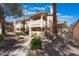 Condo building exterior showcasing well-maintained landscaping, private balconies, and convenient stair access at 912 Falconhead Ln # 101, Las Vegas, NV 89128
