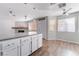 Open concept kitchen offering stainless appliances, granite counters, island seating and bright lighting at 912 Falconhead Ln # 101, Las Vegas, NV 89128