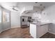 Modern kitchen boasts stainless steel appliances, white cabinetry, and a breakfast bar at 912 Falconhead Ln # 101, Las Vegas, NV 89128