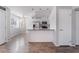 Modern kitchen featuring stainless steel appliances, breakfast bar and open layout to the living room at 912 Falconhead Ln # 101, Las Vegas, NV 89128