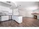 Bright and airy kitchen and living area with white cabinets, granite counters, and fireplace at 912 Falconhead Ln # 101, Las Vegas, NV 89128