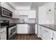 Updated kitchen featuring stainless steel appliances, white subway tile backsplash, and modern finishes at 912 Falconhead Ln # 101, Las Vegas, NV 89128