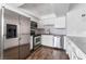 Updated kitchen boasts stainless steel appliances, white cabinetry, and subway tile backsplash at 912 Falconhead Ln # 101, Las Vegas, NV 89128
