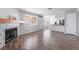 Bright open-concept living space with stylish fireplace, wood floors, and views of the kitchen at 912 Falconhead Ln # 101, Las Vegas, NV 89128