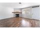 Bright living room featuring a stylish fireplace, wood floors, and a freshly painted color scheme at 912 Falconhead Ln # 101, Las Vegas, NV 89128