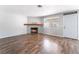 Bright living room featuring a stylish fireplace, wood floors, and a freshly painted color scheme at 912 Falconhead Ln # 101, Las Vegas, NV 89128