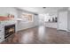 Open-concept living room with a fireplace flows into a modern kitchen at 912 Falconhead Ln # 101, Las Vegas, NV 89128