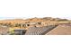 An aerial view shows the roofline of several homes in a desert community with mountain views at 964 Edinburgh Fields Ct, Las Vegas, NV 89138