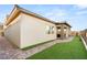 Backyard with pavers, green artificial turf and a covered patio sitting area at 964 Edinburgh Fields Ct, Las Vegas, NV 89138