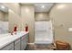 Bright bathroom featuring white countertop, gray cabinets, and glass-enclosed shower at 964 Edinburgh Fields Ct, Las Vegas, NV 89138