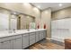 Modern bathroom features a double vanity, white countertops, and a glass-enclosed shower at 964 Edinburgh Fields Ct, Las Vegas, NV 89138