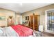 Bright bedroom featuring hardwood floors, stylish furniture, and a private balcony at 964 Edinburgh Fields Ct, Las Vegas, NV 89138