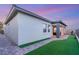 Exterior of a home with a covered patio, artificial grass, and a brick paver walkway at 964 Edinburgh Fields Ct, Las Vegas, NV 89138