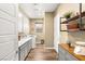 Functional laundry room with cabinetry, modern appliances, and wood-look flooring at 964 Edinburgh Fields Ct, Las Vegas, NV 89138
