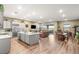Bright, open-concept living space with hardwood floors, a kitchen island, and sliding doors to the patio at 964 Edinburgh Fields Ct, Las Vegas, NV 89138