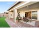 Lovely covered patio area with desert landscaping and outdoor furniture near sliding glass doors at 964 Edinburgh Fields Ct, Las Vegas, NV 89138