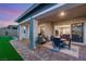 A beautiful outdoor patio with furniture and artificial grass. A sliding door leads to the interior at 964 Edinburgh Fields Ct, Las Vegas, NV 89138