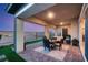 Covered patio with a brick floor and a patio table with four chairs and a beautiful twilight sky at 964 Edinburgh Fields Ct, Las Vegas, NV 89138