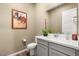 Cozy powder room with a white vanity, neutral walls, and stylish decor at 964 Edinburgh Fields Ct, Las Vegas, NV 89138