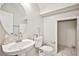 Cozy powder room with a pedestal sink, toilet, and a glimpse into a storage closet at 9717 Villa Lorena Ave, Las Vegas, NV 89147