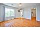 Spacious bedroom features hardwood floors, neutral walls, large window, and chandelier at 9717 Villa Lorena Ave, Las Vegas, NV 89147