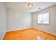 Bright bedroom features hardwood floors, neutral walls, window and chandelier at 9717 Villa Lorena Ave, Las Vegas, NV 89147