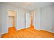 Bright bedroom features hardwood floors, neutral walls, chandelier, and closet at 9717 Villa Lorena Ave, Las Vegas, NV 89147