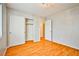 Bright bedroom features hardwood floors, neutral walls, chandelier, and closet at 9717 Villa Lorena Ave, Las Vegas, NV 89147