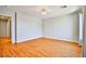 Spacious bedroom features hardwood floors, neutral walls, chandelier, and closet access at 9717 Villa Lorena Ave, Las Vegas, NV 89147