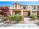 Charming two-story home featuring neutral stucco and a cozy front porch with well-maintained landscaping at 9717 Villa Lorena Ave, Las Vegas, NV 89147