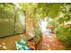 Landscaped brick patio features a window view, planter, and shaded area at 9717 Villa Lorena Ave, Las Vegas, NV 89147