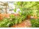 Cozy brick-paved patio features lush greenery, flowers, and a grill for outdoor enjoyment at 9717 Villa Lorena Ave, Las Vegas, NV 89147