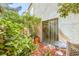 Outdoor patio with sliding glass doors, mature landscaping, and a cozy seating area at 9717 Villa Lorena Ave, Las Vegas, NV 89147