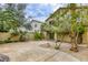 Landscaped backyard with mature trees, gravel beds, a large patio, and a spiral staircase at 9966 Mystic Moss St, Las Vegas, NV 89183