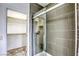 Modern bathroom with tiled shower and glass door next to walk-in closet at 9966 Mystic Moss St, Las Vegas, NV 89183