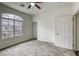 Carpeted bedroom with a large window that floods the space with natural light at 9966 Mystic Moss St, Las Vegas, NV 89183